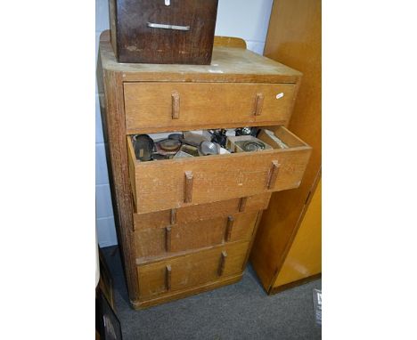 Oak chest of drawers. five drawers each, filled with watch and clock maker's components, cabinet width 61cms.