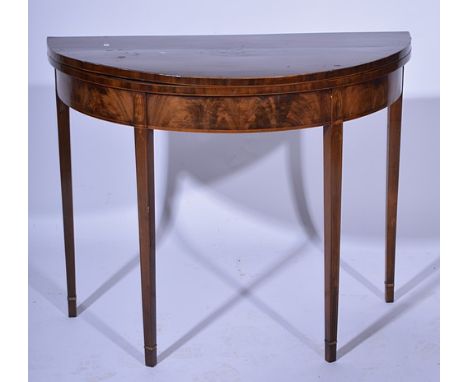 George III mahogany demi-lune card table, the top with a marquetry oval, banding and stringing, square tapering legs, width 9