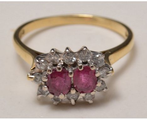 18ct ruby and diamond ring, two centre rubies, surrounded by twelve diamonds.