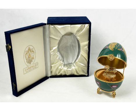 MUSICAL FABERGE EGG, number thirteen, green and gilt ceramic with hinged lid enclosing gilt unicorn in original box, 20cm H. 
