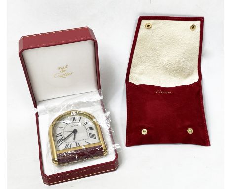 CARTIER ROUIANE ALARM CLOCK, Must de Cartier, arched dial in gilt metal and red enamel case in original fitted box with pouch
