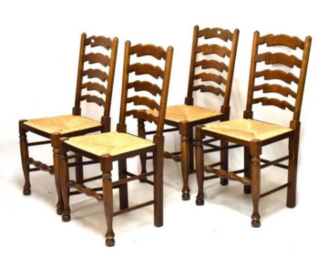 Four ladder-back rush seated dining chairs, purchased from 'Molloy's Furnishers Limited, Southport'