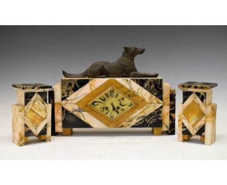 Art Deco mantel clock and garniture with cast metal dog surmount, 31cm high (tallest)