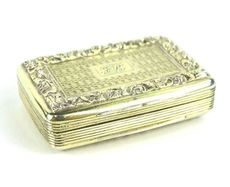 A Victorian silver gilt rectangular vinaigrette, the top and bottom with raised border surrounding engine turning and a monog