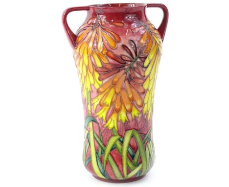 A Moorcroft two handled trial vase, decorated with brightly coloured orange, red, pink flowers, with leaves, various marks to