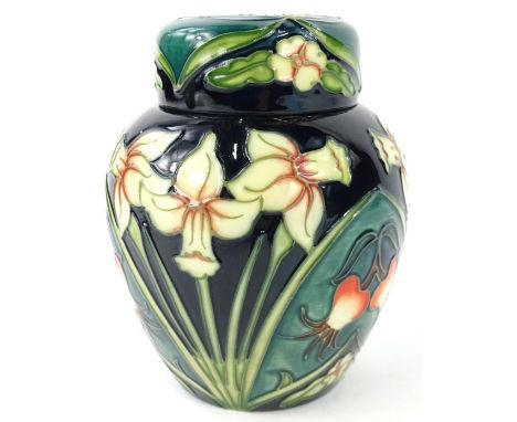 A Moorcroft Carousel pattern ginger jar, decorated with daffodils, rosehips, primroses etc., on a mottled green ground, desig