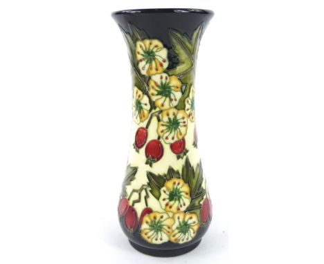 A Moorcroft Hawthorne pattern vase, decorated with berries, flowers, etc. on a blue and cream ground, designed by Nicola Slan