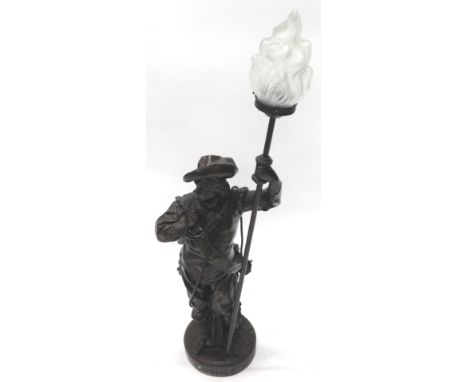 A bronzed figure lamp base, modelled in the form of a soldier holding a lantern with frosted shade, 107cm H.