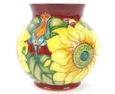 A Moorcroft Inca pattern vase, decorated with sunflowers, flowers etc., on a rust ground, designed by Rachel Bishop, tube lin