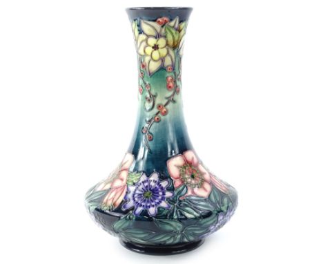 A Moorcroft Centenary year Carousel range bottle shaped vase, decorated with columbine, redcurrants, hellebore and passion fl