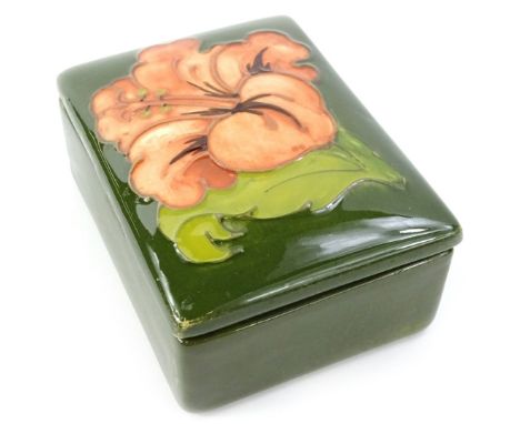 A Moorcroft Coral Hibiscus pattern small box and cover, designed by Walter Moorcroft, 9.5cm W.