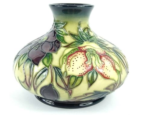 A Moorcroft squat vase, decorated with flowers, leaves etc., impressed and handwritten mark to underside, 12cm diameter.