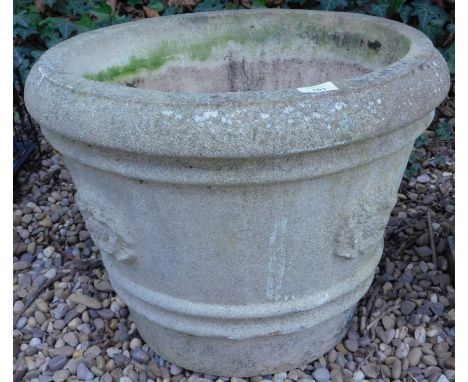 A composition garden urn or planter, cast with flower heads etc, 56cm diameter.