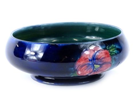 A William Moorcroft Pansy pattern shallow bowl, hand scripted mark and impressed potter to the Queen, 15cm diameter.