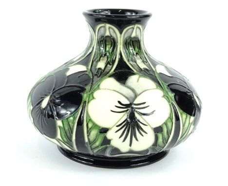 A Moorcroft pottery squat vase, decorated with black and white pansies interspersed by leaves, handwritten and impressed mark