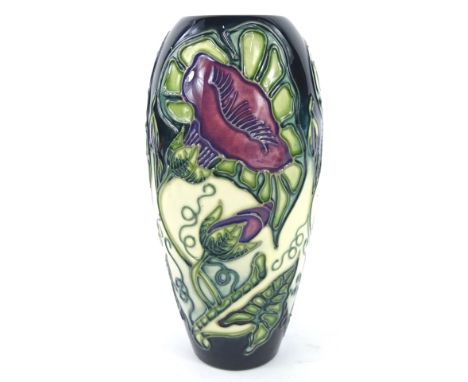 A Moorcroft Convulvulus pattern vase, decorated with flowers and vines etc. on a dark green and cream ground, designed by Deb