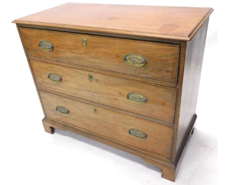 An early 19thC mahogany chest of drawers, with a rectangular top with a moulded edge above three long drawers with oval brass
