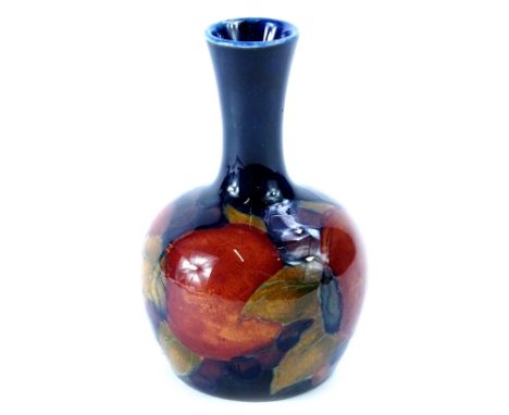 A Moorcroft Pomegranate pattern bottle shaped vase, decorated with fruit, on a cobalt blue ground, indistinct marks to unders