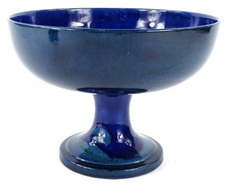 A Moorcroft Moonlit Blue pattern tazza, decorated with trees on a blue ground, signed W. Moorcroft in green to underside, imp