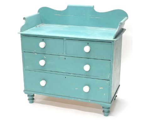 A Victorian pine wash stand, with a shaped raised gallery, above two short and two long drawers, each with ceramic handles on