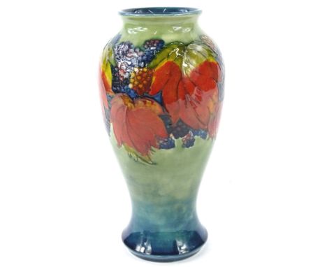 A William Moorcroft Blackberry and Leaf pattern vase, on a green and blue ground, signed Moorcroft to underside, 23cm H, boxe