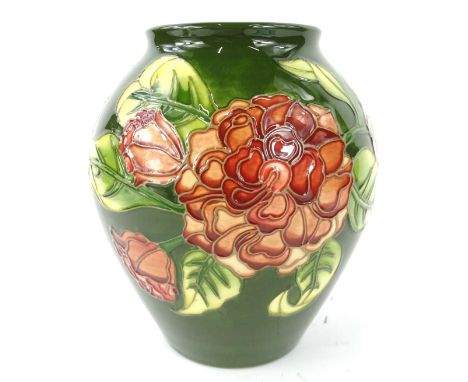 A Moorcroft Camellia pattern vase, decorated with flowers and leaves, on a green ground, designed by Debbie Hancock, No. 27 o