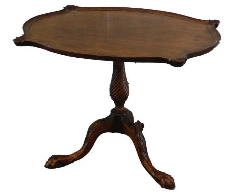 A mahogany occasional table, the rectangular top with a serpentine pie crust type border, with shell carving to each corner, 