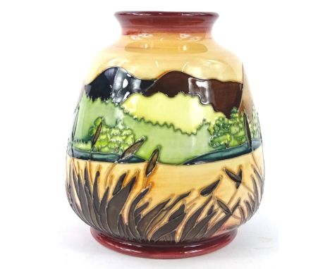 A Moorcroft colour trial vase, decorated with a rural landscape on a mottled red and orange ground, signed D.L. Hancock, 25.1