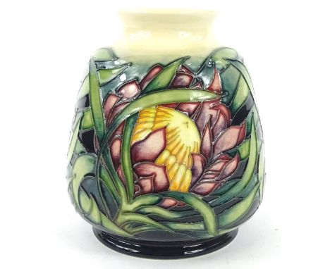 A Moorcroft Protea pattern vase, decorated with flowers and leaves on a cream and green ground, designed by Emma Bossons, tub