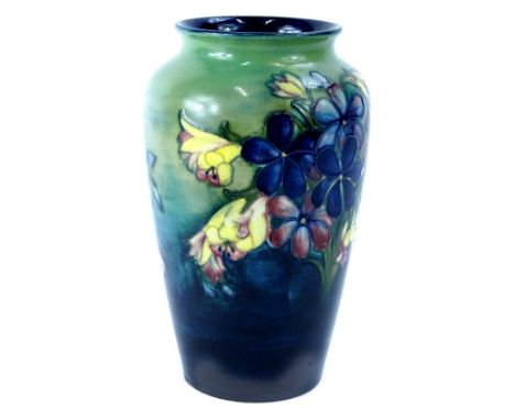 A Moorcroft pottery Spring Flowers pattern vase, decorated with flowers on a mottled blue and green ground, impressed and han