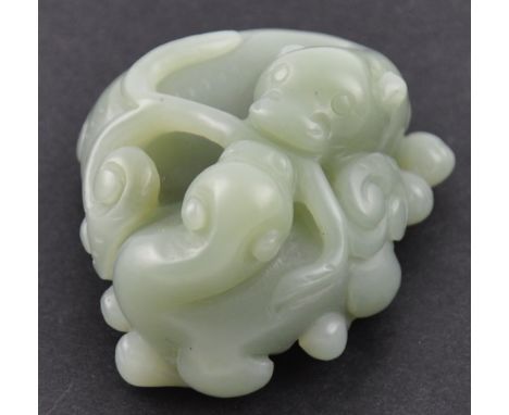 A Chinese carved jade figure of two mythical beasts