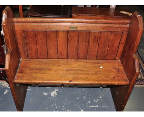 A late Victorian small stained pine pew with iron handle, w:92cm, together with a Victorian style painted pine wall shelf