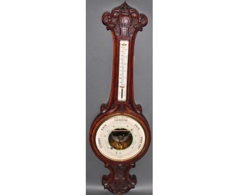 A 1940s carved oak aneroid barometer, with integral thermometer, H. 82cm