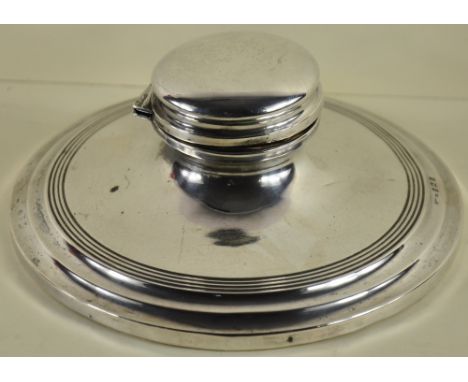 A large solid silver Capstan inkwell with ceramic liner hallmarked Birmingham 1907