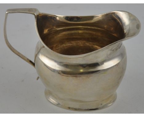 A George III helmet shaped silver milk jug hallmarked London 1809