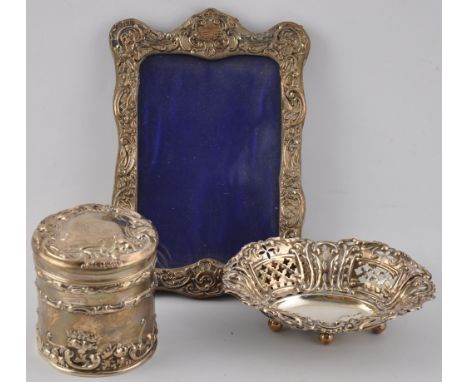 A George V silver mounted dressing table jar and cover together with an oval pierced silver bon bon dish and a silver mounted