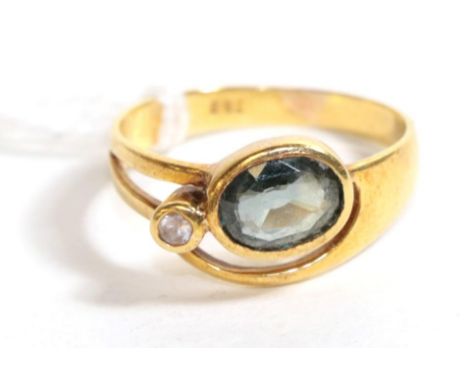 A green and white sapphire ring, stamped '750', finger size M.  Gross weight - 3.45 grams. 