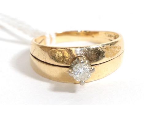 A diamond solitaire ring, stamped '14K-18K', finger size O.  Gross weight - 4.36 grams. 