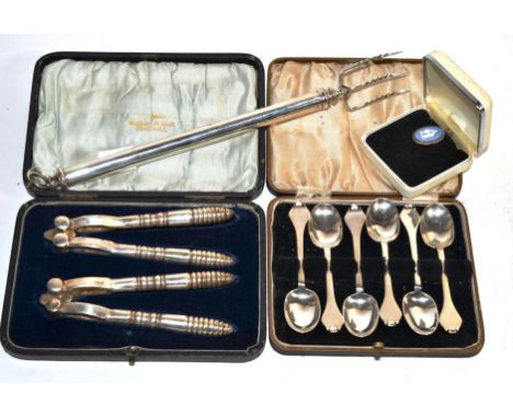 An Edwardian silver telescopic toasting fork; a set of six silver trefid teaspoons; a pair of nut crackers; and a Wedgwood pe