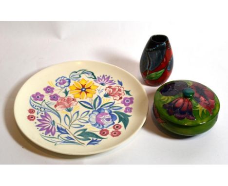 A Moorcroft pottery circular dish and cover; a small Poole vase; and a Poole plate 