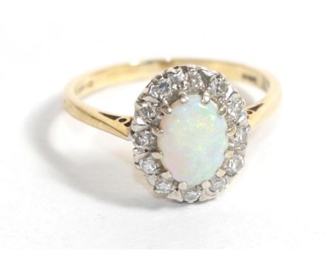 A 9 carat gold opal and diamond cluster ring, finger size M1/2.  Gross weight - 2.54 grams. 