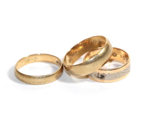 An 18 carat gold band ring, finger size N; and two 9 carat gold band rings, finger sizes O and S (3).  18 carat gold ring - 4