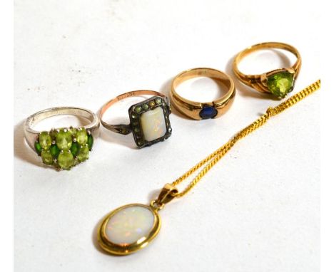 An opal pendant, chain length 46cm; a peridot ring, stamped '925', finger size N; an opal and paste ring, stamped '9CT &amp; 