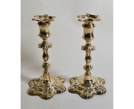 A pair of silver candlesticks of 18th Century style, Henry Wilkinson &amp; Co, London 1893, filled, (split to one stem) 24cm 