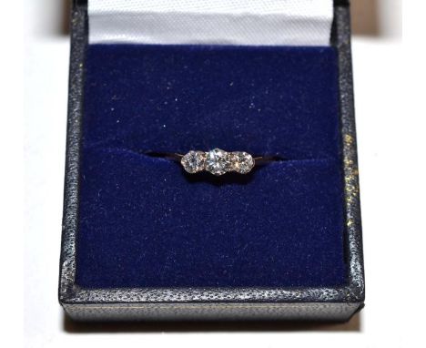 A three stone diamond ring, stamped '18CT', finger size K.  Gross weight - 1.12 grams. 