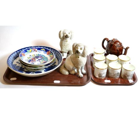 A blue and white charger; seven Spode coffee cans; a pair of Staffordshire poodles; and a Cadogan teapot 