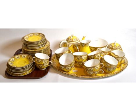 A Royal Worcester gilt highlighted and yellow ground porcelain part tea service comprising oval tray, large sugar bowl, twin 