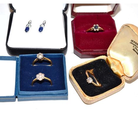 Four gem set dress rings, stamped '18CT', finger sizes M, M, M and Q; and a pair of sapphire earrings, unmarked .  Four rings