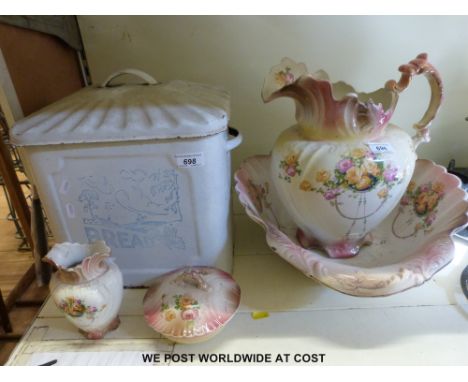A jug and bowl set together with an enamel bread bin with countryside design