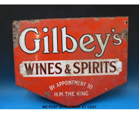 A double sided enamel advertising sign 'Gilbey's Wines and Spirits by appointment to H M The King' (42 x 53cm) 